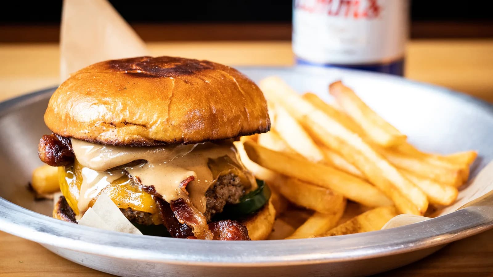 A Copper Athletic Club burger on a brioche bun with a side of natural cut fries