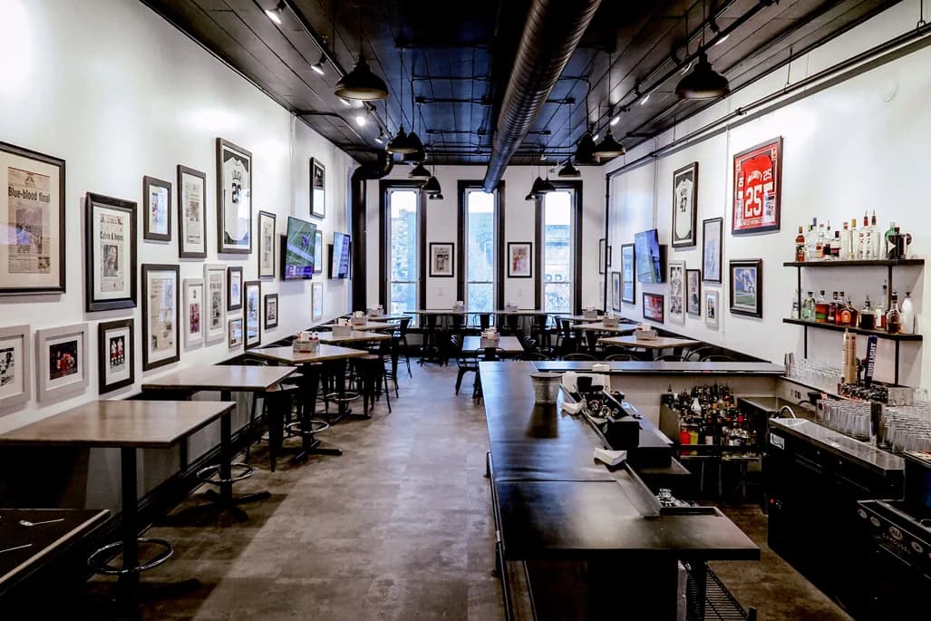 The Copper Reserve, a long private room with communal tables and walls of framed memorabilia